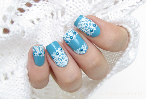 Blue nails with white lace and studs